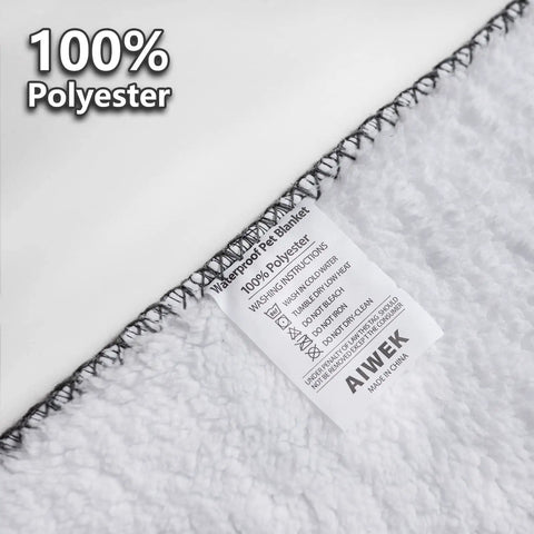 Close-up of Waterproof Pet Blanket For Dogs And Cats With Pattern Print showing care label and stitching detail.