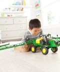Child playing with One Sixteen Scale Self Propelled Sprayer Toy That Feels Like The Real Deal With Functional Water Sprayer Lights