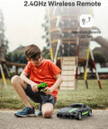 Boy playing with Mercedes Benz GT R Pro 1/12 Scale RC Car Official Licensed Drift Vehicle With Realistic Body outdoors.