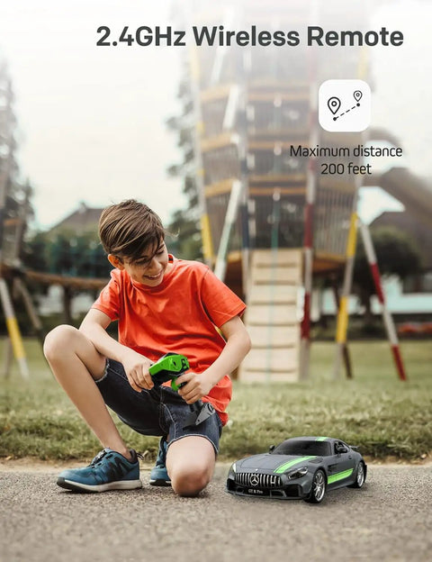 Boy playing with Mercedes Benz GT R Pro 1/12 Scale RC Car Official Licensed Drift Vehicle With Realistic Body outdoors.