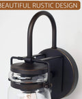 Close-up of Wyer 11.5 Inch Farmhouse Industrial Wall Sconce With Gooseneck Arm Clear Glass Jar Shade Dimmable Oil Rubbed Bronze Finish.