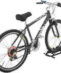 Mountain bike on Foldable Bike Rack Floor Stand For Easy No Hassle Bike Storage Fits 20mm To Two Point Four Inch Wide Tires On 650C 700C Road Wheels And 20 To 29 Inch MTB BMX Bikes Heavy Duty Powder Coated Steel.