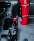 Slick Under Seat Fire Extinguisher Bracket For Ineos Grenadier Truck With One Hand Quick Release Aluminum Mount Kit And Heavy Duty Secure Ratchet Straps installed with fire extinguisher and trigger handle.