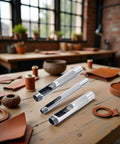 Three Piece Grommet Hole Punch Set With Steel Hollow Punches For Leatherworking And Crafts on a workshop table