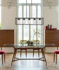 Elegant dining room with modern chandelier above glass table and chairs, showcasing Clear Glass Lamp Shade Replacement Globe for decor.