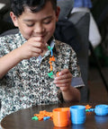Child playing with colorful 3D printed toys from Beginner Friendly 3D Printer For Kids With Easy Setup And Safe Design.