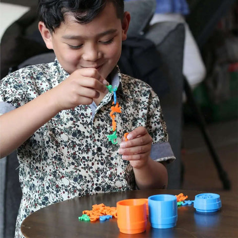 Child playing with colorful 3D printed toys from Beginner Friendly 3D Printer For Kids With Easy Setup And Safe Design.