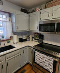 Modern kitchen with 25 Pair Set of Self-Closing Half Inch Overlay Cabinet Hinges in Black on gray cabinets above stove