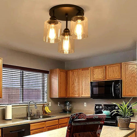 Three Light Industrial Semi Flush Mount Ceiling Fixture With Vintage Clear Seeded Glass Shade, Black Finish in kitchen
