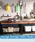 Wall-mounted steel hooks organizing garage tools and gear, including a rake, shovel, and cables, demonstrating use of 2 Pack Heavy Duty Garage Storage Utility Hooks For Tools And Garden Gear, Steel Wall Mount U Hooks Black, Holds 40 Lbs, Space Saving Organizer For Cables, Hoses, Brooms, Spades, Bikes, And More.