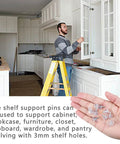 Man installing cabinets with 5 Millimeter Clear Plastic Shelf Support Pins Pack Of 20, showing pegs in hand, kitchen renovation scene
