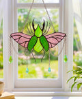 Stag Beetle Stained Glass Kit For Beginners With Pre Cut Pieces on window with vibrant green and pink glass suncatcher