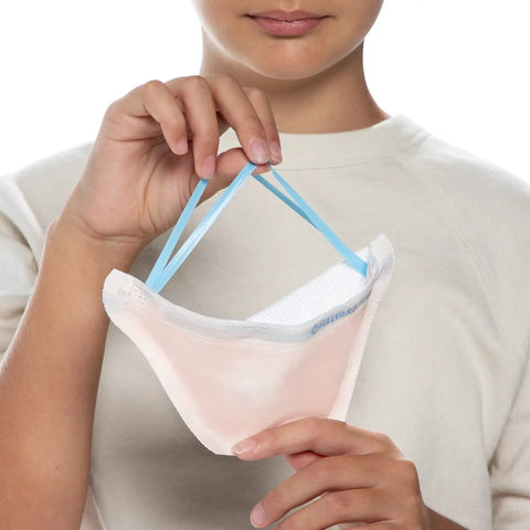 A person holding a FluidShield N95 Respirator Mask With ASTM Level 3 Protection Small Orange Face Cover with bonded straps.