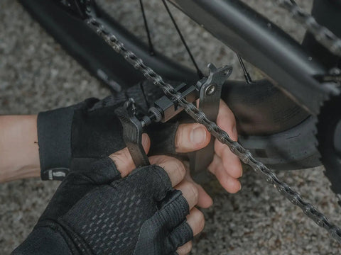 Person using Five In One Bike Tool with Chain Tool and Master Link Pliers for on-the-go bike maintenance