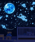 Glow In The Dark Stars Ceiling Set With Moon And Space Wall Decals in a kid's room, creating a starry night sky vibe above a crib.