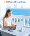 Woman using 20W Travel Power Strip With 4 Outlets And 3 USB Ports Including USB C 4 Ft Wrapped Extension Cord Flat Plug at seaside.