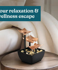 Tabletop Water Fountain With Three Tiers For Indoor Zen Waterfall Vibe on round table, natural river rocks, home decor.