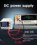 Adjustable DC Power Supply 0 To 30V 0 To 10A with Encoder Knob, 4 Digit LED Display, connected to multimeter, on dark background