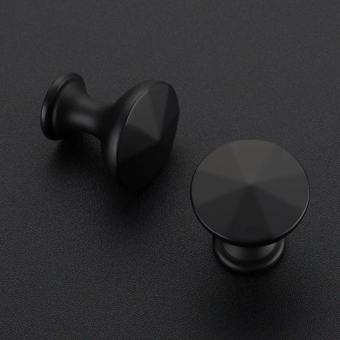 Matte Black Cabinet Knobs 10 Pack Solid Metal Sunburst Top Drawer Pulls For Kitchen Cabinets Bathrooms Vanities And Dressers Easy Single Hole Install For Modern Hardware Look, showcasing two knobs on dark surface.