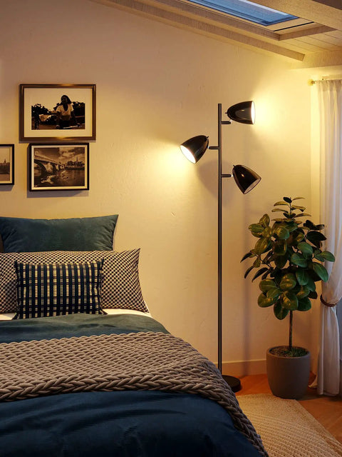 Three 9W LED Bulbs Included Floor Lamp With 3 Adjustable Rotating Heads in a cozy bedroom setting