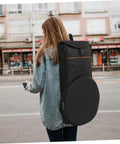 Woman carrying Road Ready Oxford Fabric Drum Storage Bag With Hella Tough Waterproof Seams on a city street.
