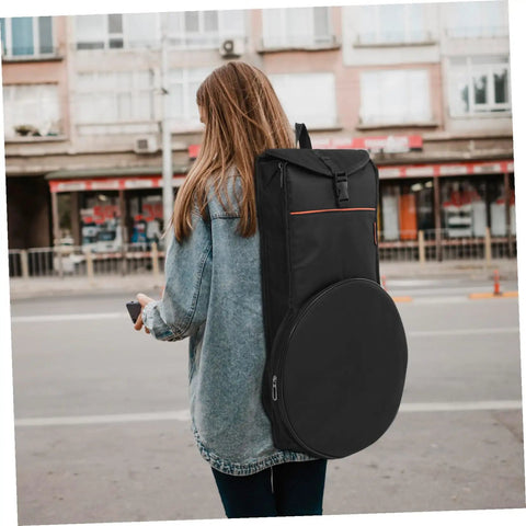Woman carrying Road Ready Oxford Fabric Drum Storage Bag With Hella Tough Waterproof Seams on a city street.