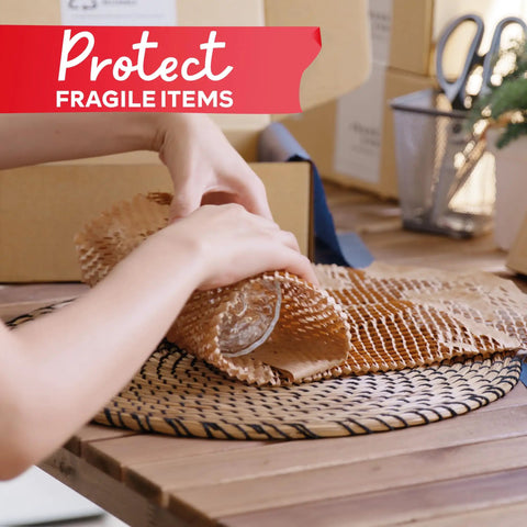 Heavy Duty Brown Honeycomb Packing Paper For No Sweat Moving Day Prep, rolling paper around fragile glass on a table.