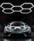 Hexagon LED Garage Lights 200W 20000LM 5 Grids 25 Pack Ceiling Shop Light 6500K Ultra Bright For Your Garage And Shop Car Care Wash Room Basement For Home And Pro Use illuminating a sleek sports car in a garage