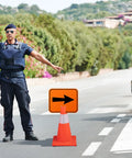 Traffic officer directing with Six Pack Orange Traffic Arrow Signs For Detours And Road Barricades Left And Right Directional Arrows