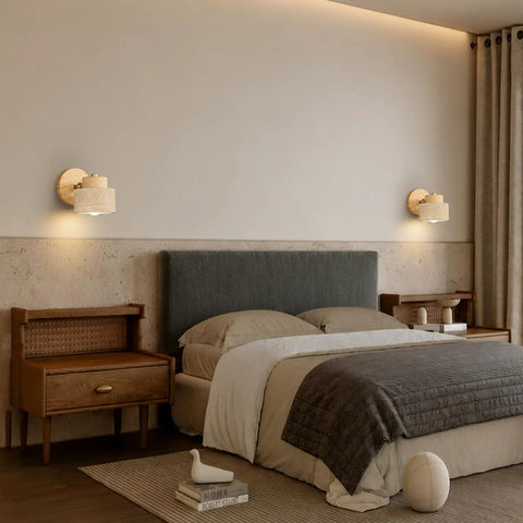 IPEDWO Yellow Travertine Wall Sconce with Natural Wood,4.7" Single Sconce mounted on a bedroom wall beside a bed.