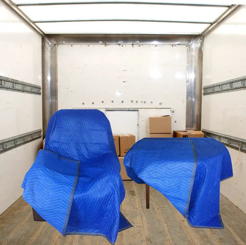 Four Pack Heavy Duty Moving Blankets For Furniture Protection Quilted Padding 72 By 80 Inches Blue covering furniture in a truck