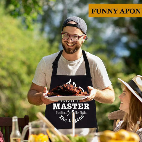 Man wearing 'Grill Master' apron holding barbecued ribs, part of 20 Piece Grilling Accessories Set For Outdoor Barbecue With Apron And Carry Bag Includes Long Spatula Tongs Fork Basting Brush Kabob Skewers Corn Holders Grill Brush And Knife For Dad