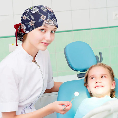Nurse wearing 8 Pack Women's Scrub Caps With Buttons in floral pattern, assisting patient in dental clinic.