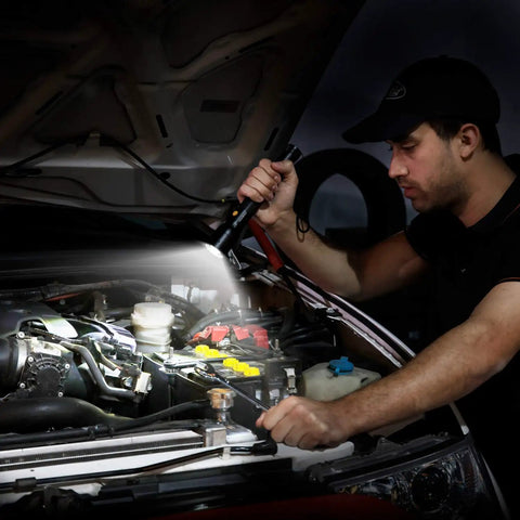 Man using Ultra Bright Tactical Flashlight With 900 Lumen Zoomable Beam And Adjustable Focus, 3 Light Modes to work on car engine