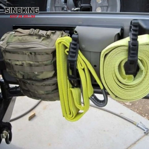 Side view of SINOKING rubber clamp on a vehicle tailgate with neon-yellow straps
