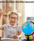 Smiling child with glasses pointing to a 10 Inch DIY World Globe For Kids Learning Hands On Assembly Educational Rotating Globe Large World Map.