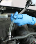 Mityvac MVA6852 1.5L fluid evacuator syringe with clear hose; gloved hand attaching to engine reservoir