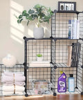 Six Cube Storage Organizer Set With Stackable Wire Grid Shelves Beefy Metal Cubes For Home Office And Kids Room Each Cube Holds Up To 22 Lbs 12 Inch Square DIY Closet Organizer In Black Space Saving And Easy To Tidy in living room with decor items
