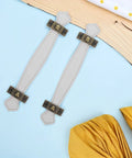 Slick Vintage Zinc Alloy Cabinet Pulls With White PU Leather Grip, 2 Pack laid out on a blue and wood surface