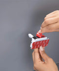 Hands applying eight piece adhesive cabinet latches in white, easy peel and stick install, no tools needed for most cabinets.
