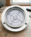 FytStycale Horizontal Circular Bubble Level | 80mm, Flange-Mounted Spirit Level on wooden surface, precision alignment measuring tool.