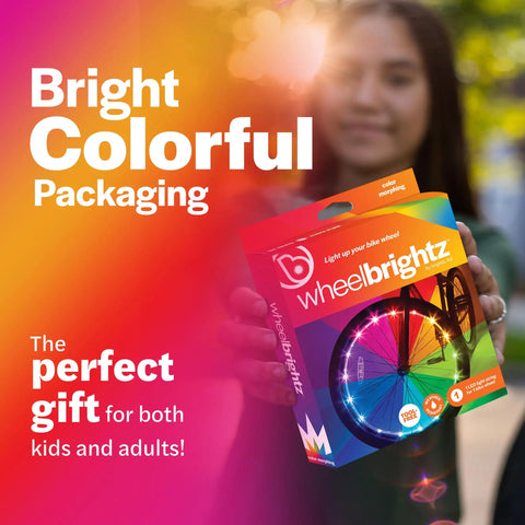 Colorful packaging of RGB LED Bike Wheel Lights For Night Rides 1 Pack, held by person showcasing bright wheel graphics.