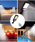 2 Pack Solar Street Lights Outdoor With 120 LED Ultra Bright Motion Sensor Remote Control IP65 Waterproof Wireless Wall Light illuminating driveway, house, garage, and pool.