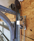 Installed LAJIAOZ garage door jackshaft chain hoist on wall with silver metal housing and drive sprocket