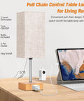 Set Of 2 Bedside Table Lamps With USB Charging Port And AC Outlet, lamp with pull chain and charging devices on wooden table