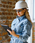 Bulk 150-Pack Safety Glasses To Stock Up The Squad, Lightweight Protective Eyewear worn for safety while using a tablet in a construction area.