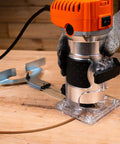 Powerful 6.5 Amp Variable Speed Wood Router Workhorse 1.25 HP Trim Router with six speed settings on workbench.