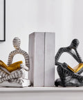 Heavy Duty Decorative Book Ends For Shelves With Thinker Statue Design on white shelf, resin material, supporting upright books.