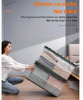 Woman organizing folded clothes in Heavy Duty Collapsible Storage Bins With Lids Super Sturdy Plastic Folding Crate.