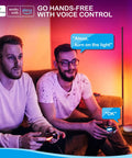 Two people using Smart RGB Corner Floor Lamp With WiFi App Control Alexa And Google Assistant in living room with gaming setup.
